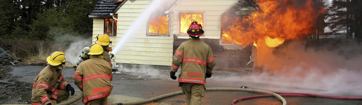 Firefighters spraying water on a housefire public safety training