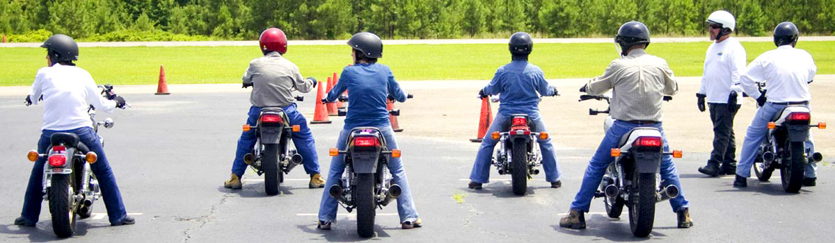 Group of students riding motorcycles at the training facility