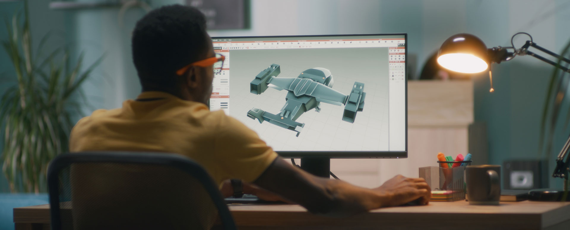 Man creatingon a 3-D model of a machine on computer