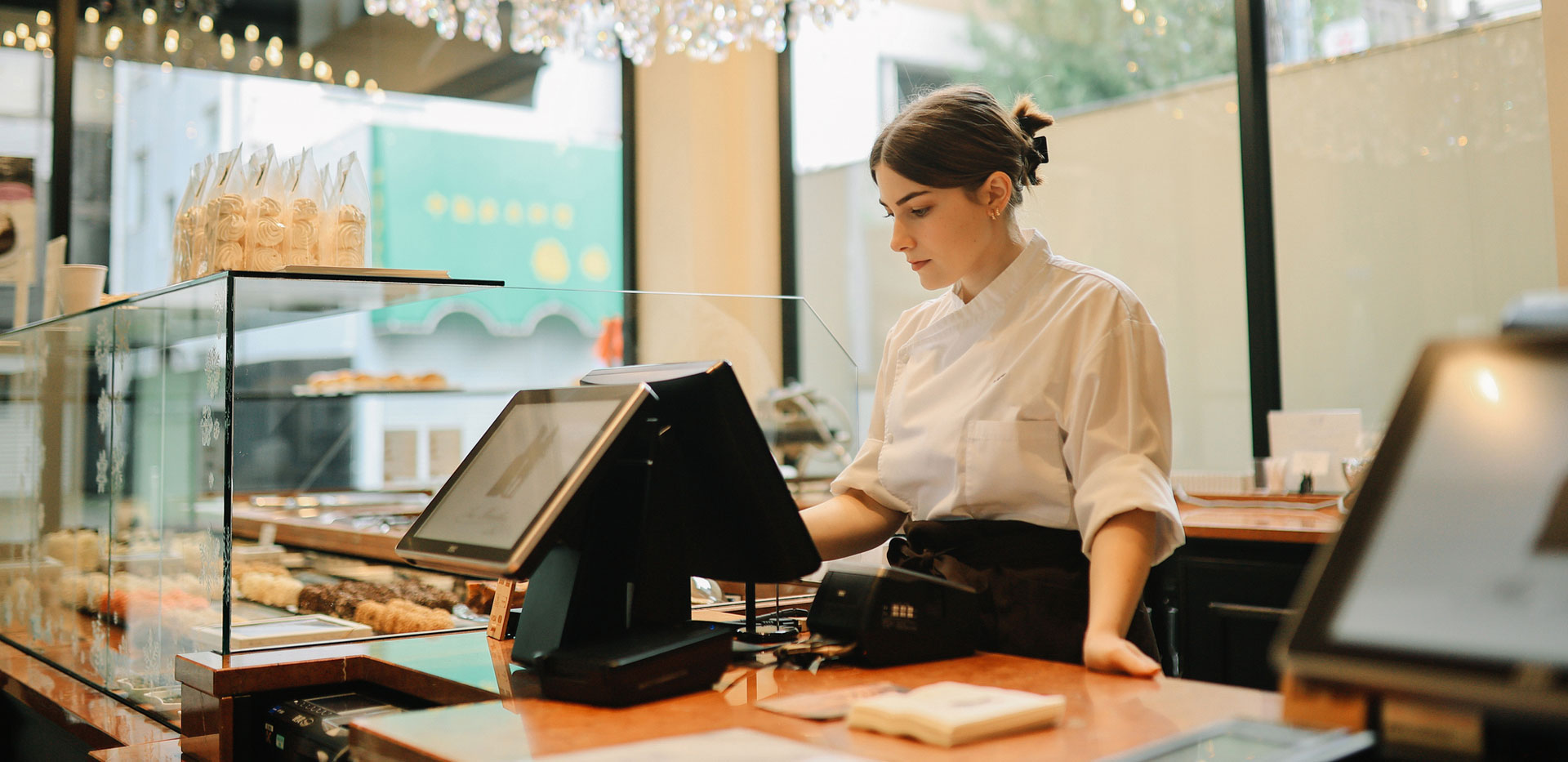 Woman working the front of house at a bakery