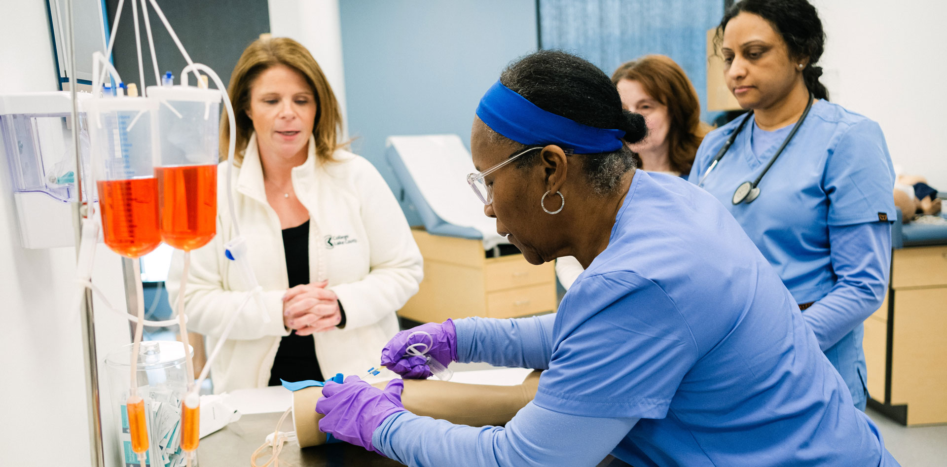 CLC instructor teaching students an important concept using hands on learning