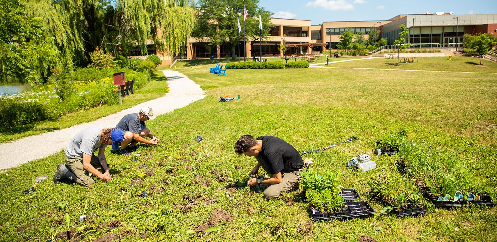 Students planting outside on the CLC campus grounds