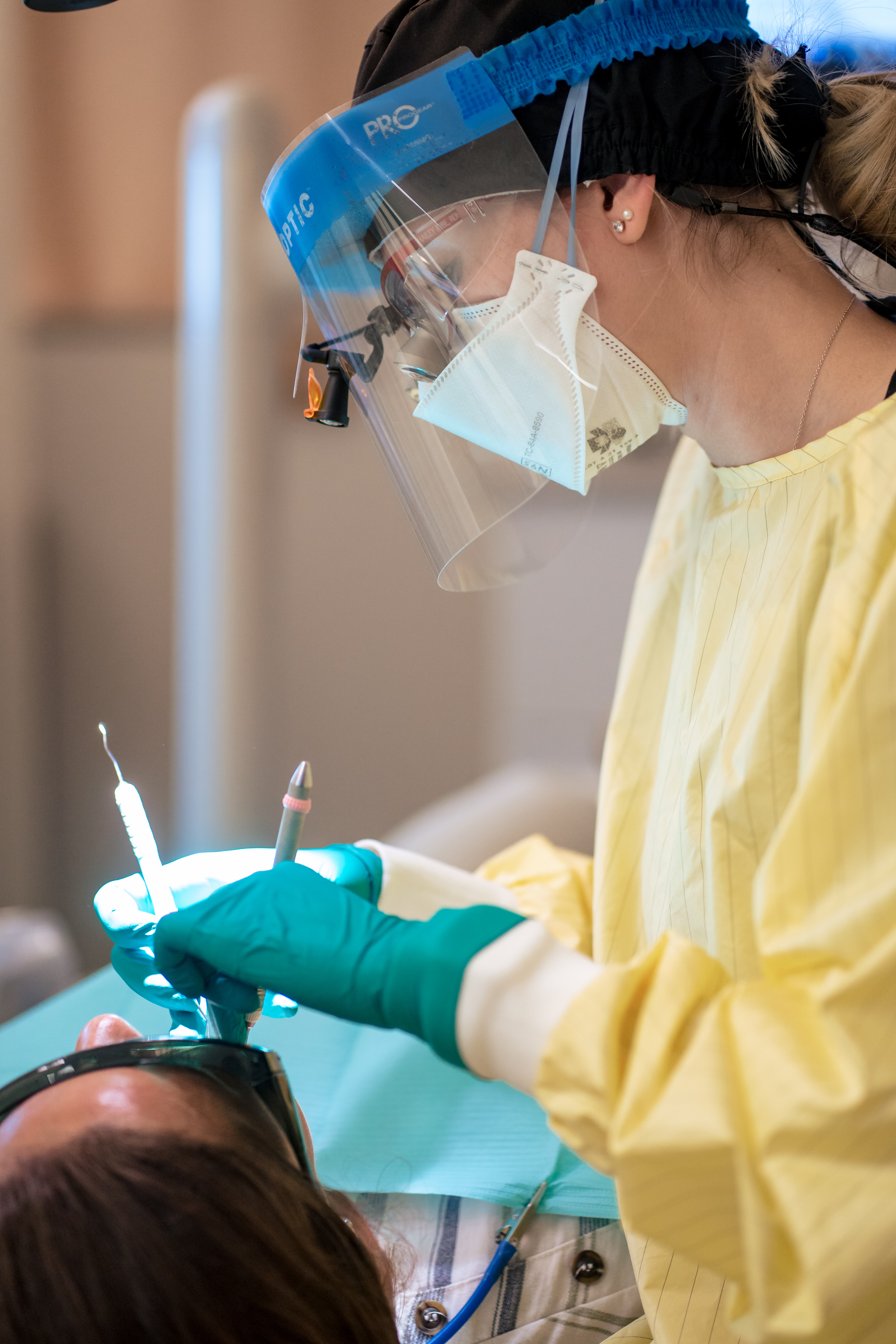 Dental Hygienist cleaning patient's teeth