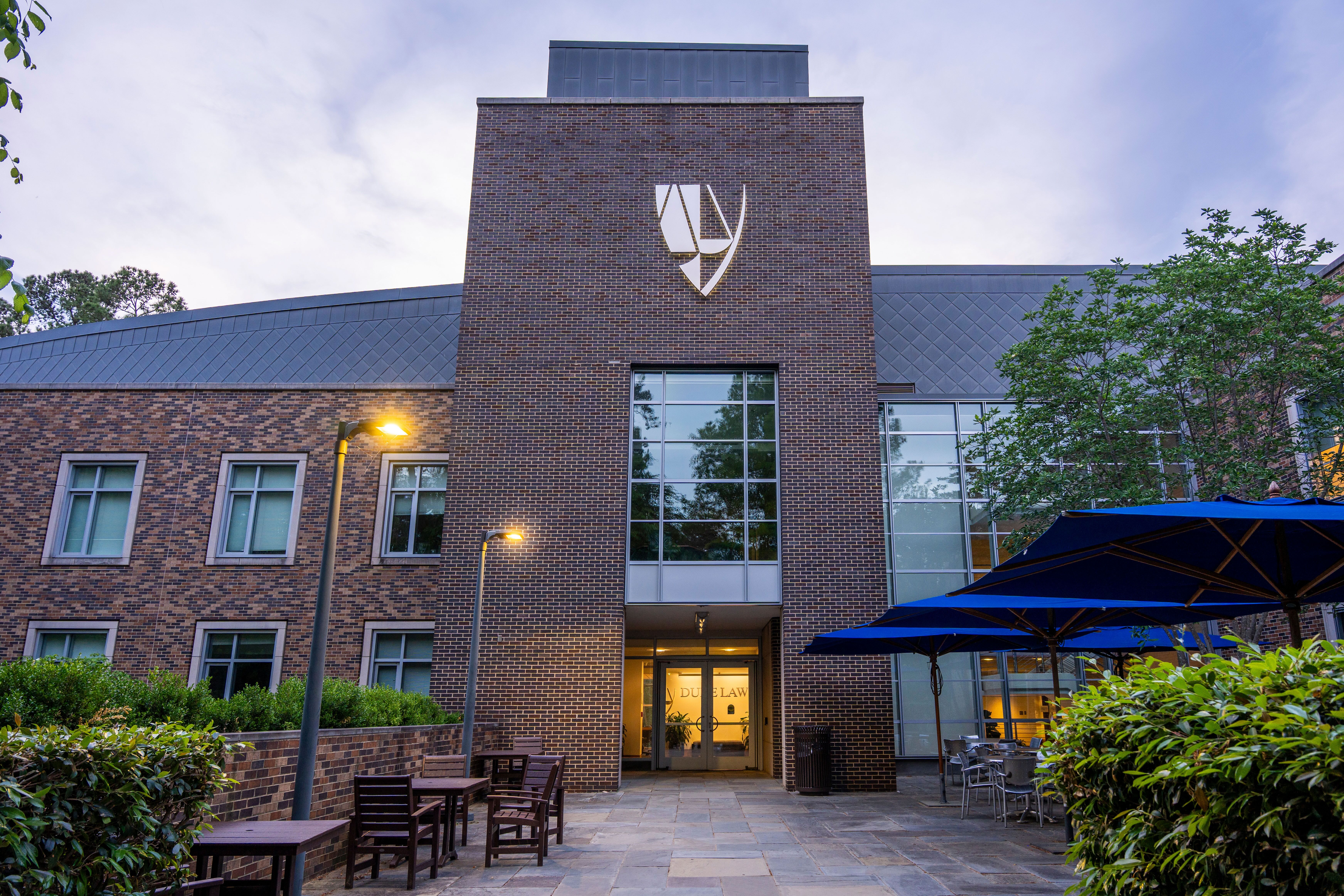 Exterior of Duke Law building during the evening.