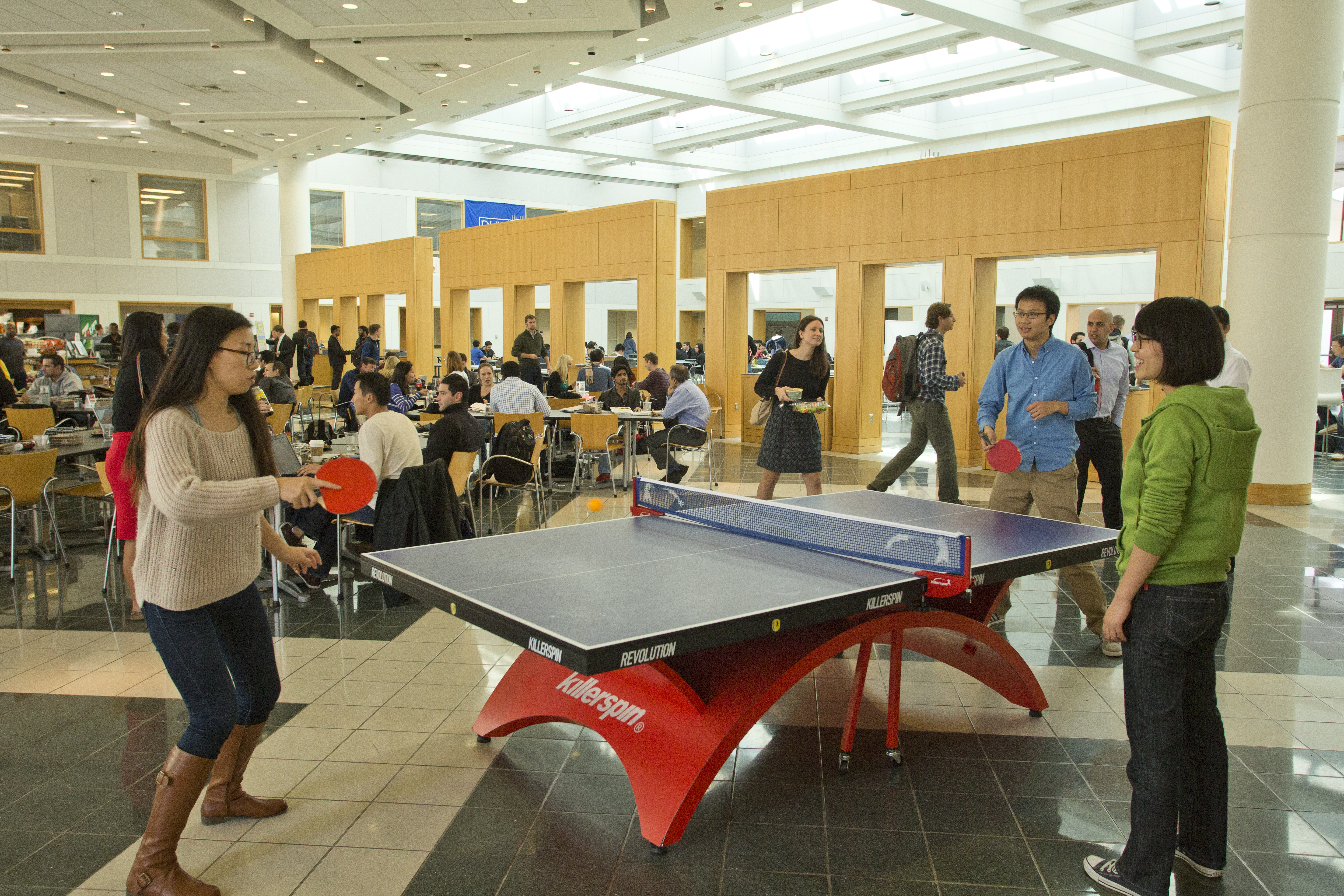 Interior view of Fox Student Center at the Fuqua School of Business with students at ping pong table