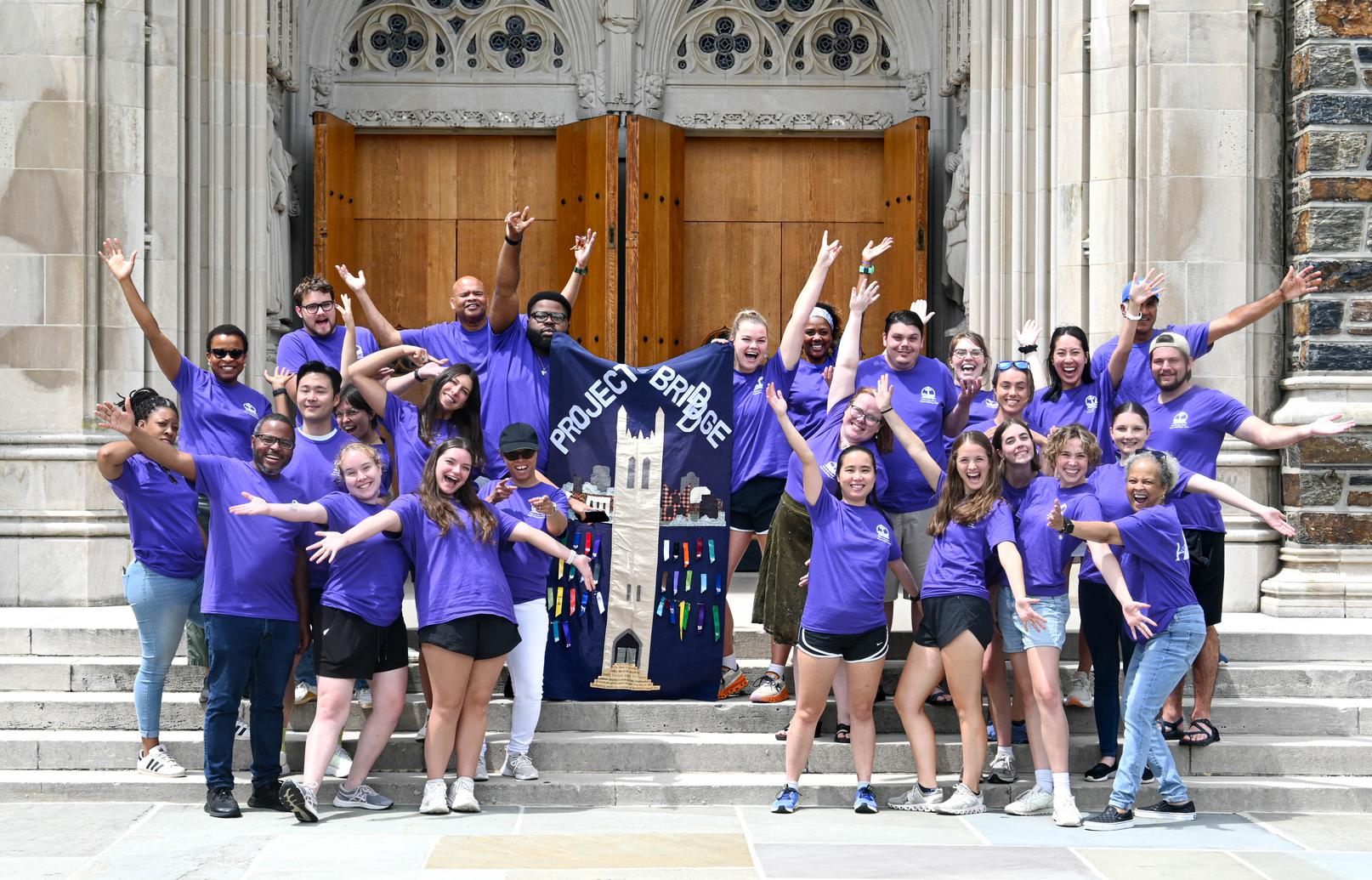 Divinity students and staff on the steps of Duke Chapel, celebrating the final day of Project BRI(DDD)GE (Building Relationships In Durham through Duke Divinity Graduate Education).