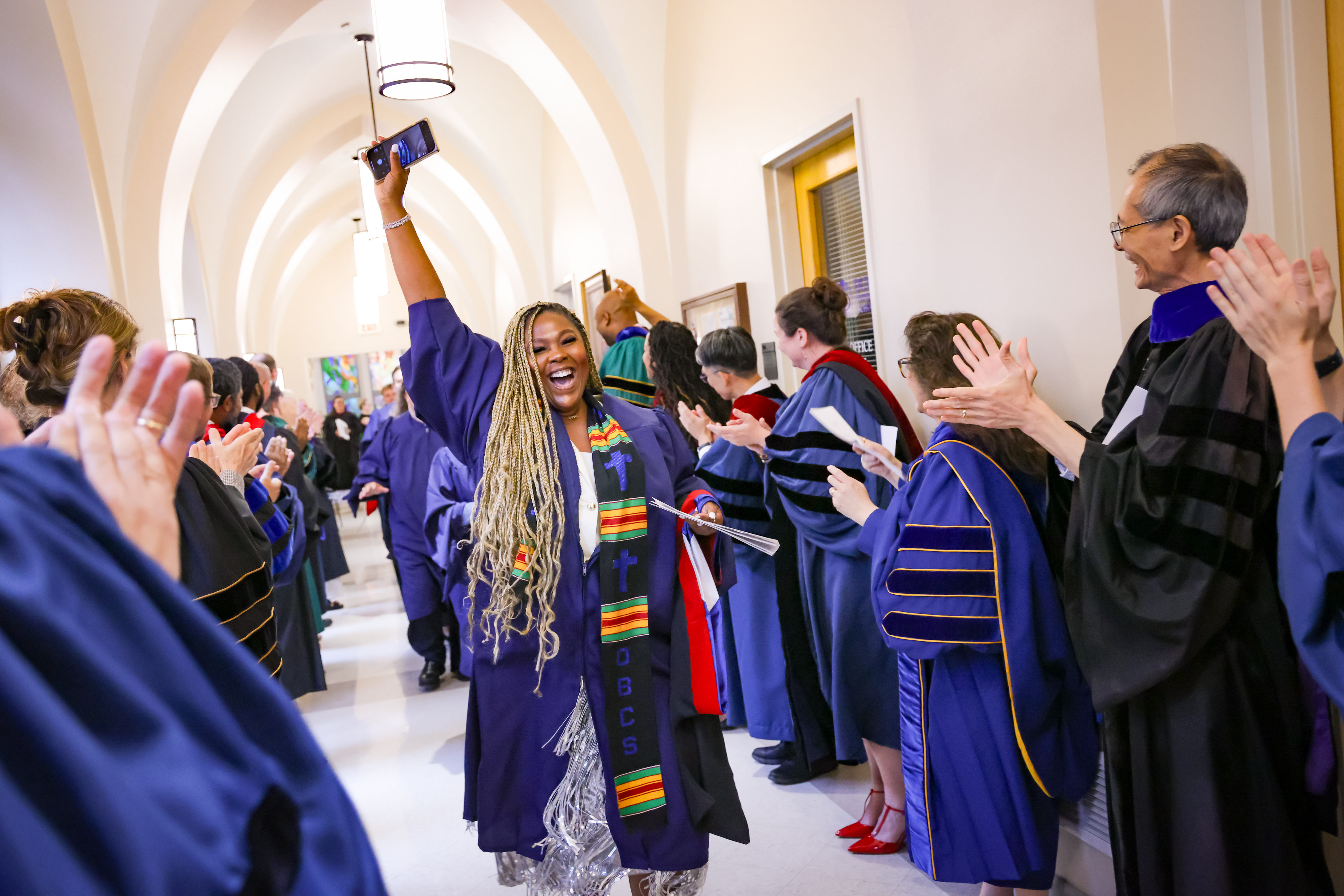 A graduating student celebrates while processing into Duke Chapel at Baccalaureate: Ken Huth/HuthPhoto