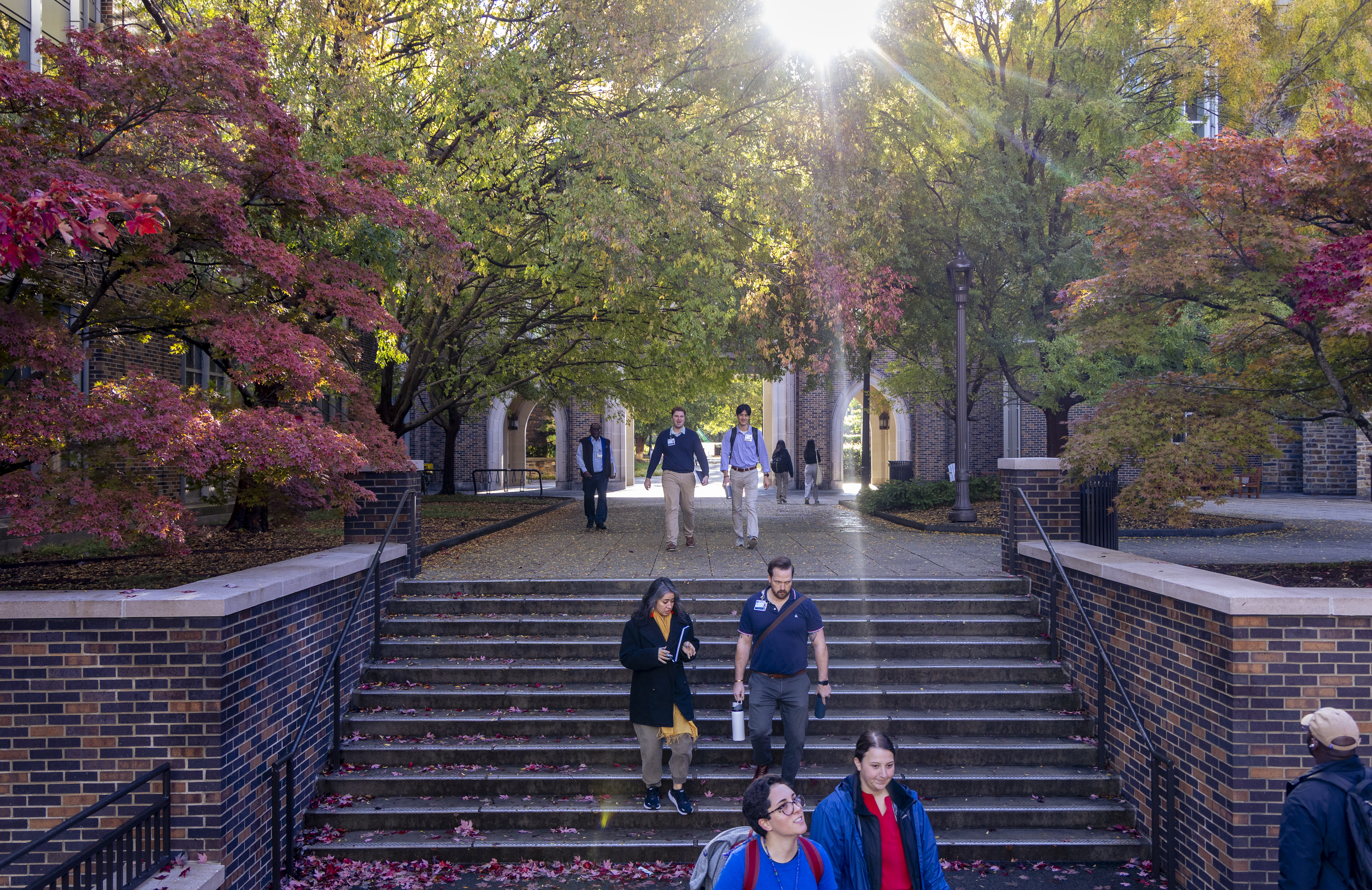 The Duke community walks between Perkins and Bostock Libraries on a beautiful late October morning: Jared Lazarus