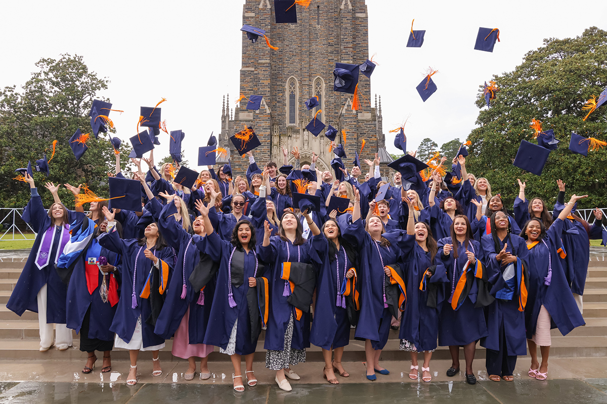 Nursing students outside in graduation cap and gowns