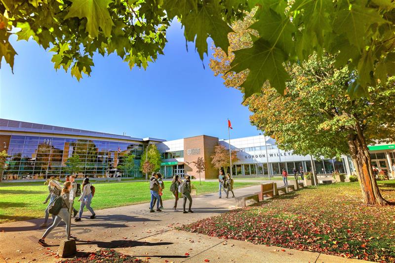 DC sign with students and Lou mascot.