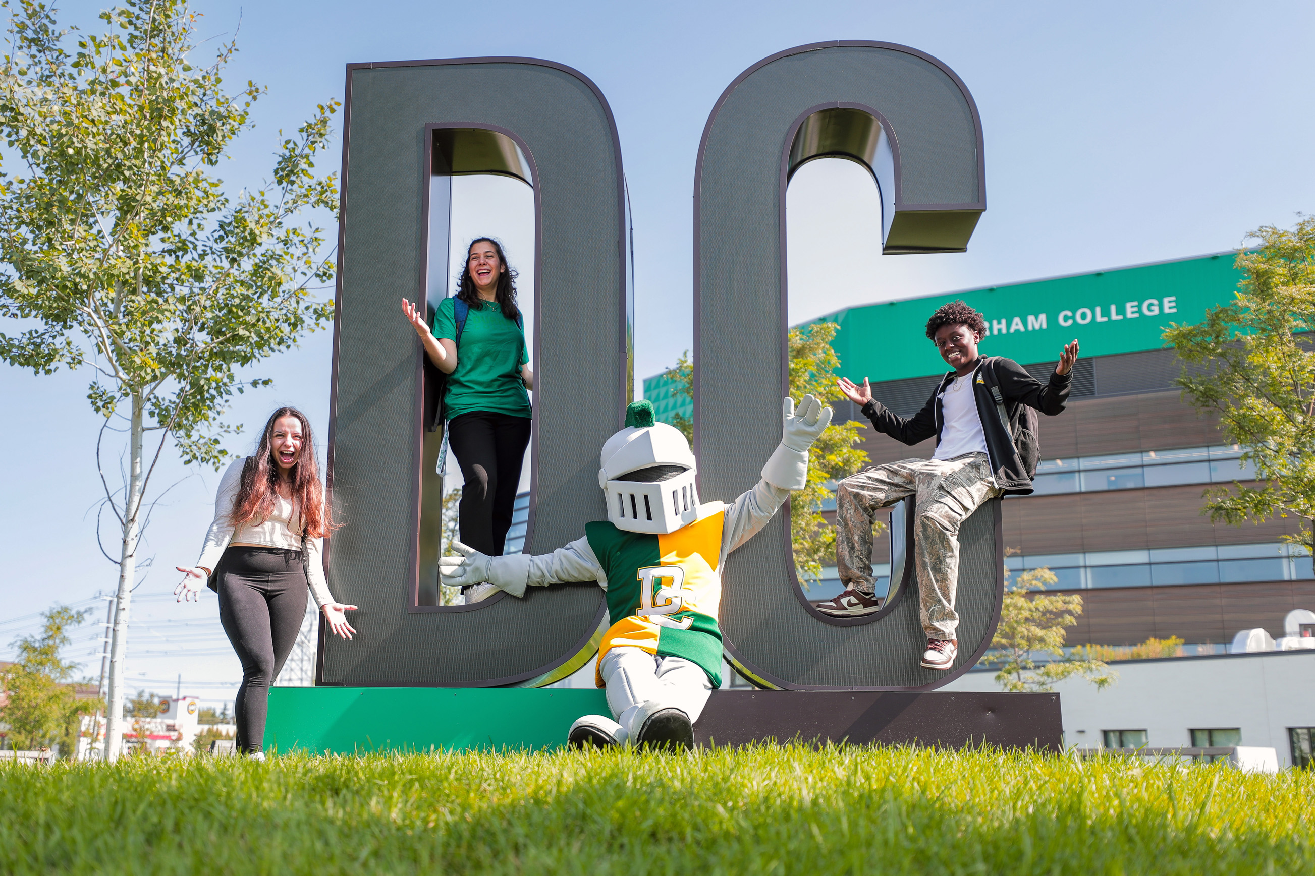 DC sign with students and Lou mascot.