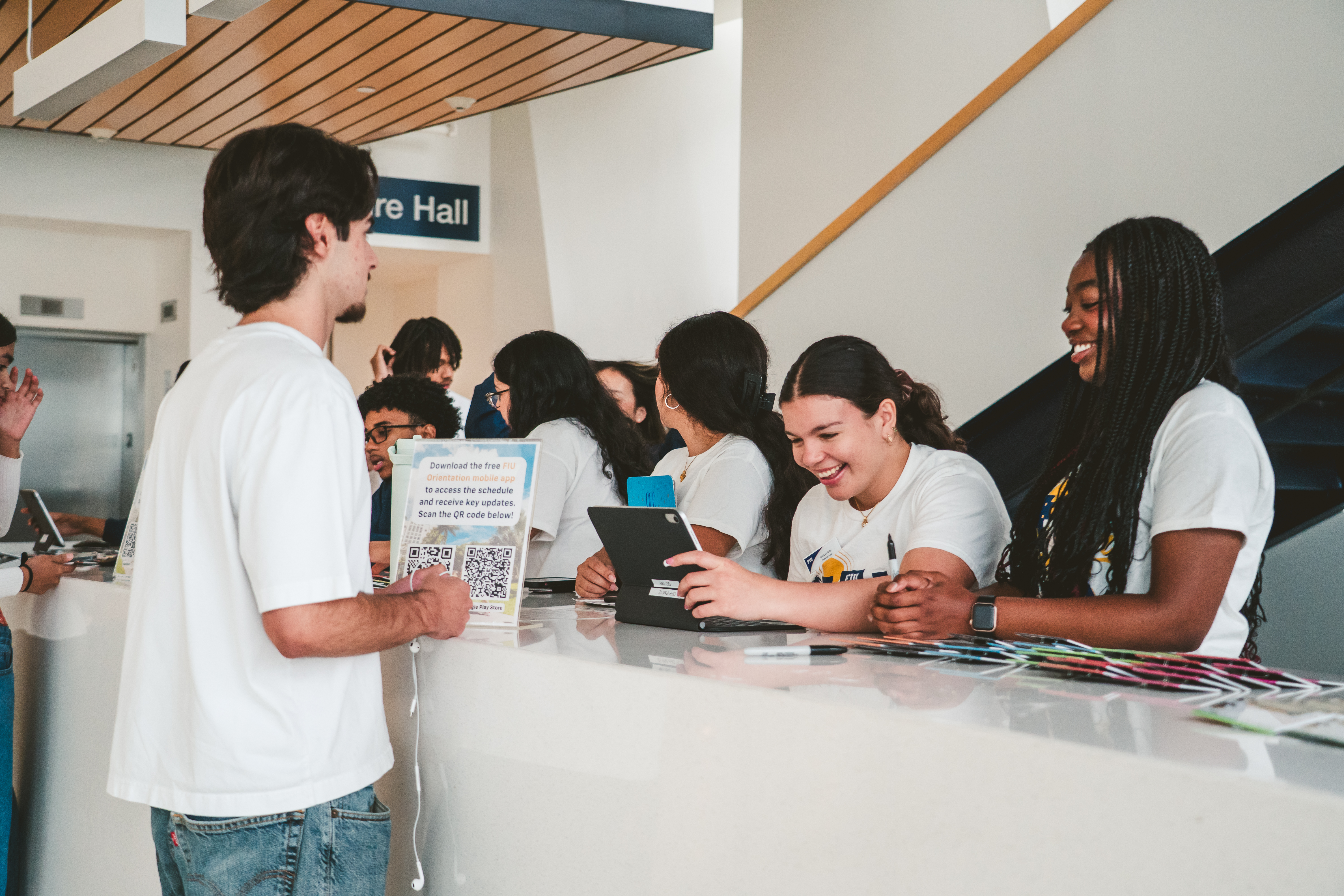 An FIU student speaking with volunteers at student counter during Admitted Students Day 2026.