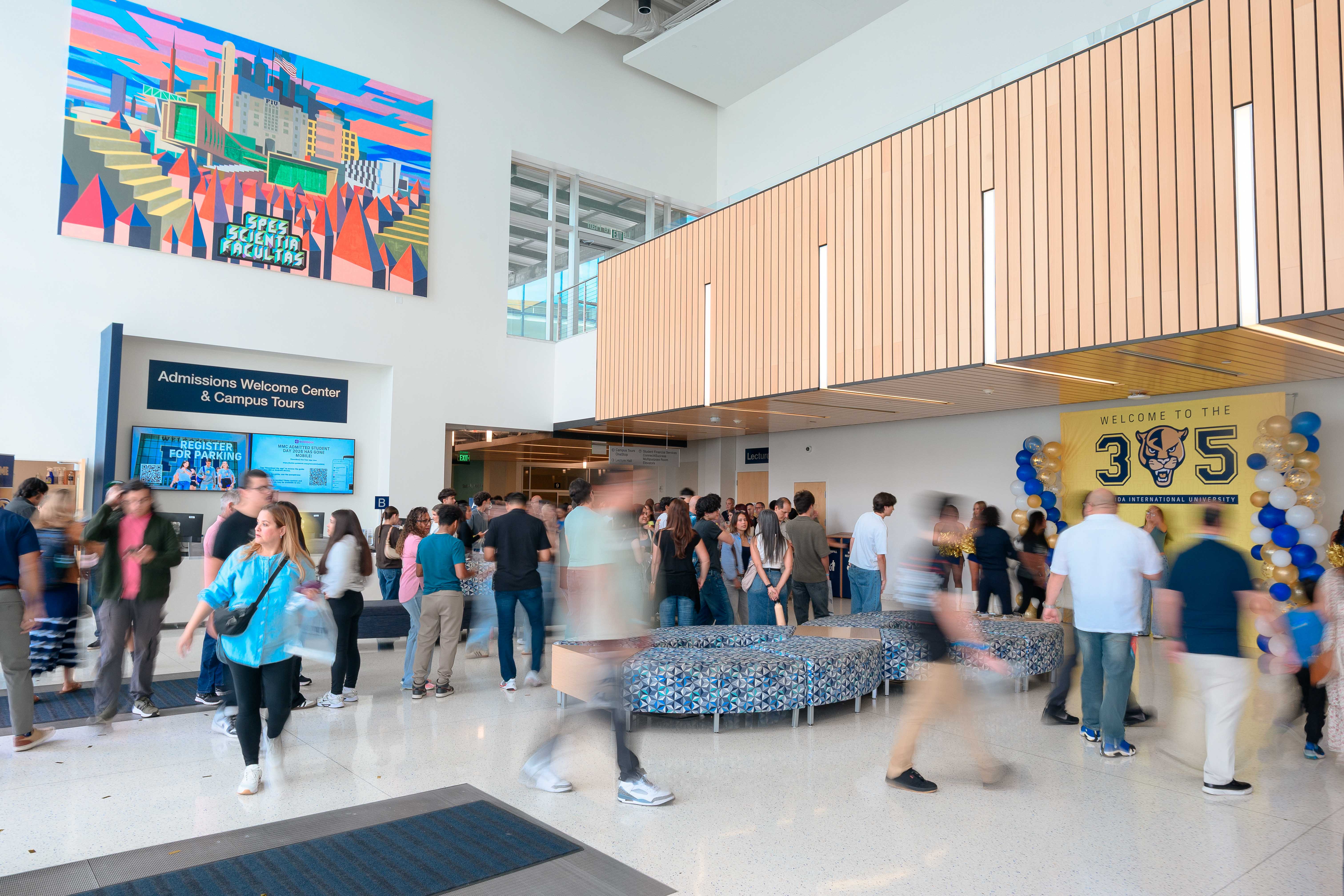 People standing in front of the Student Admissions Welcome Center and Campus Tours