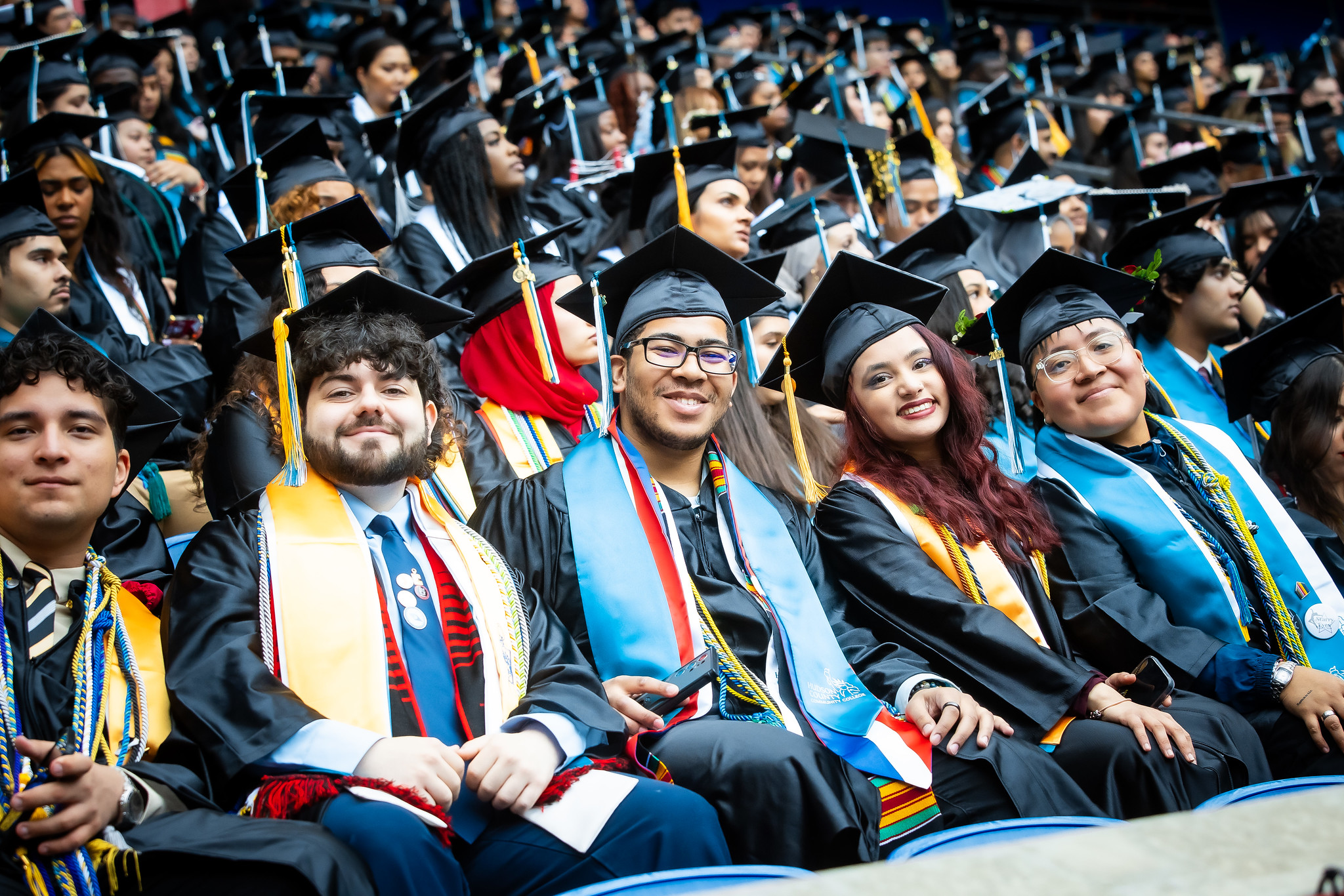 Students smiling at Commencement.