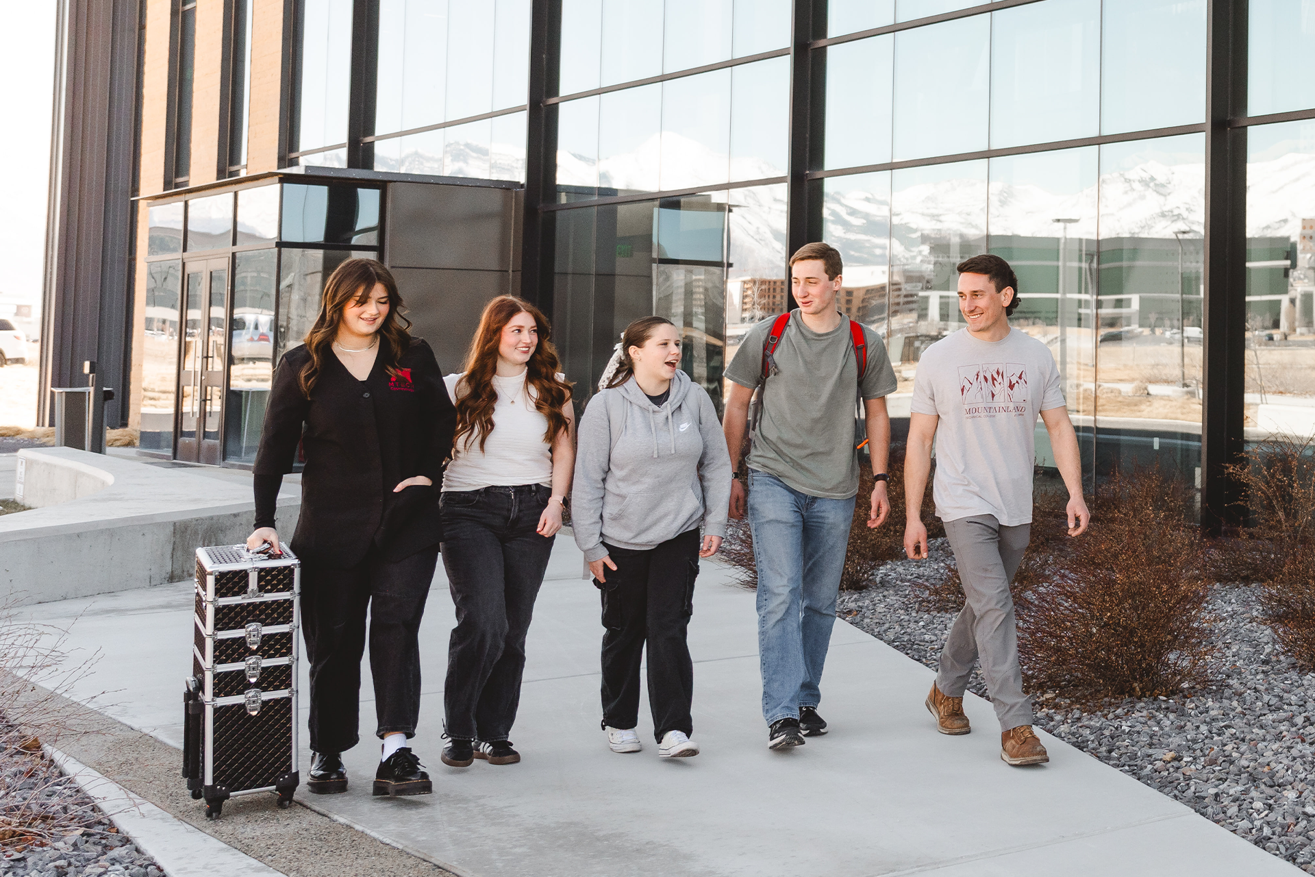 Five students walking outside.