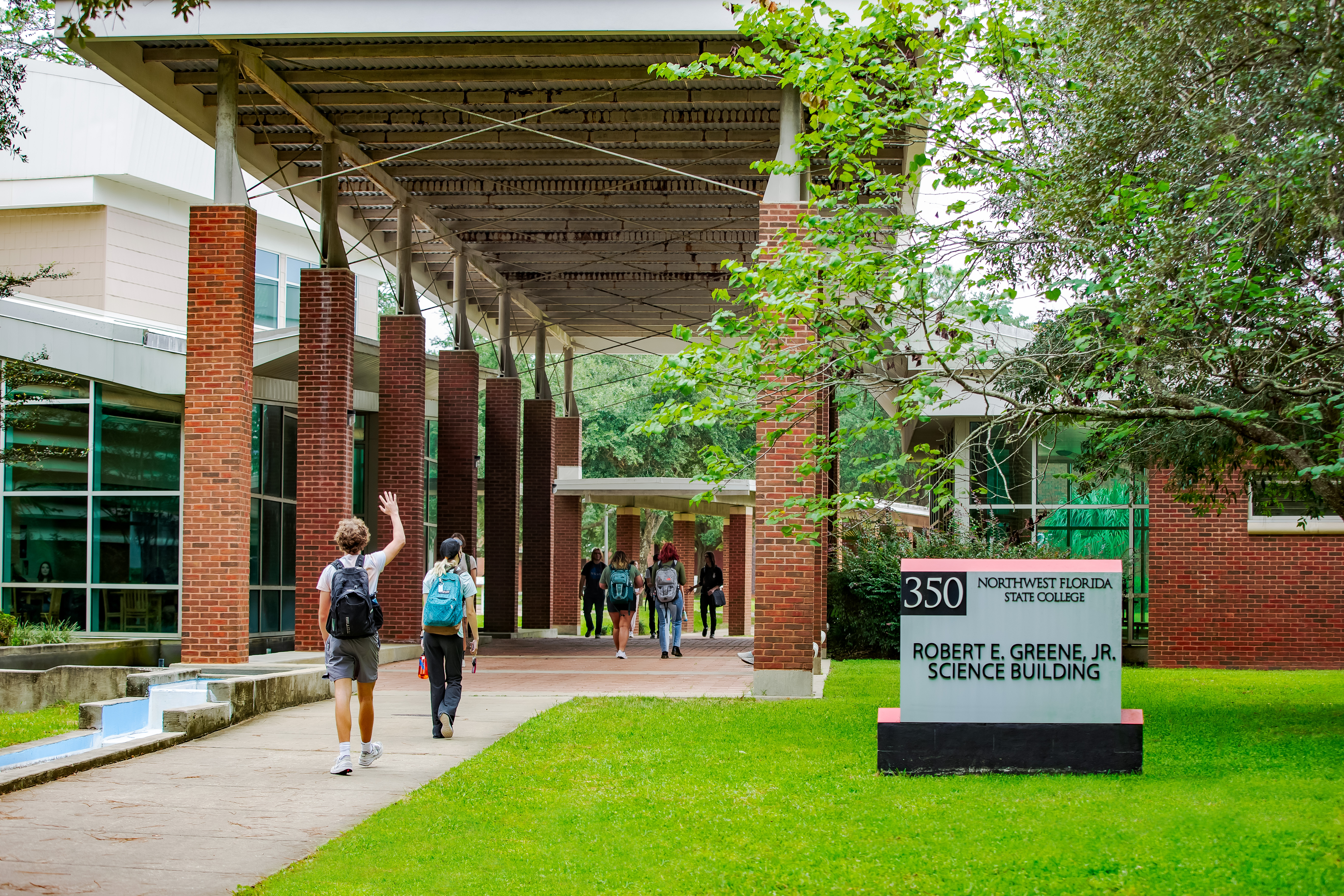 Group of students walking through a breezeway near Building 350