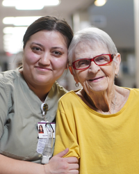 CNA supporting an older patient.