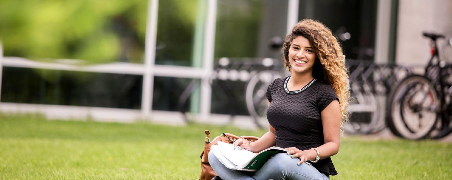 Heading image with a girl holding a book