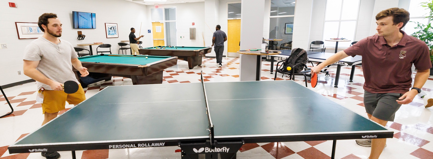 A group of students playing ping pong in the Recreation Center.