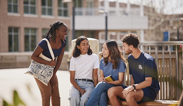 students outside the Osprey Cafe sitting and talking