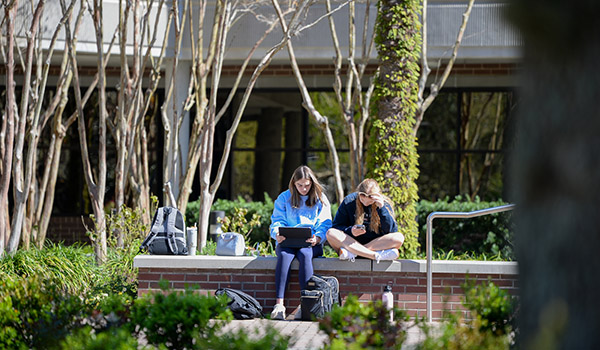 Two females on bench studying
