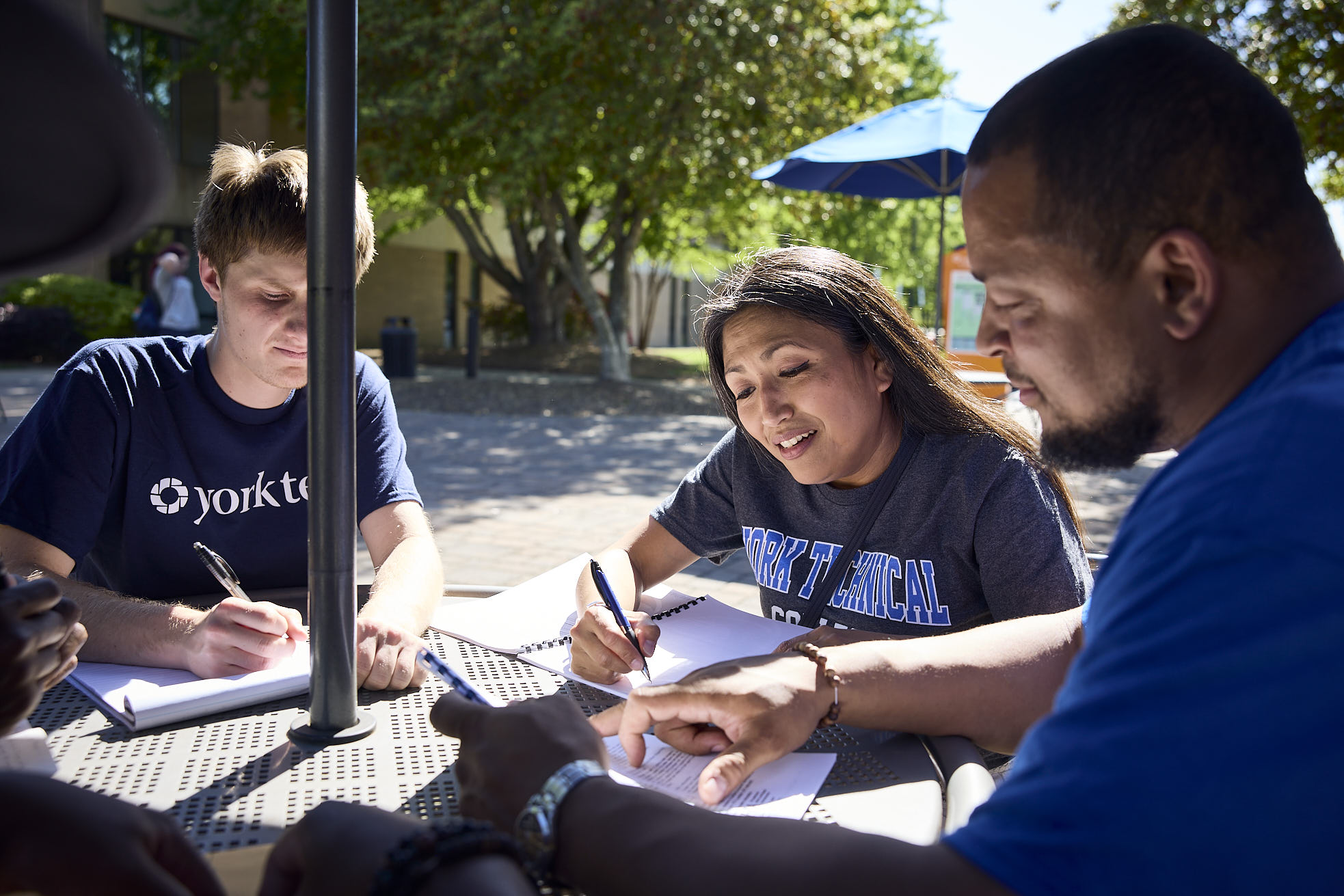 York Tech students doing classwork at an outdoor table